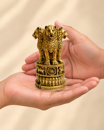Illustrative scale view of Ashoka Lion Capital Brass Sculpture resting on an adult open palm; listed height 4 inches.