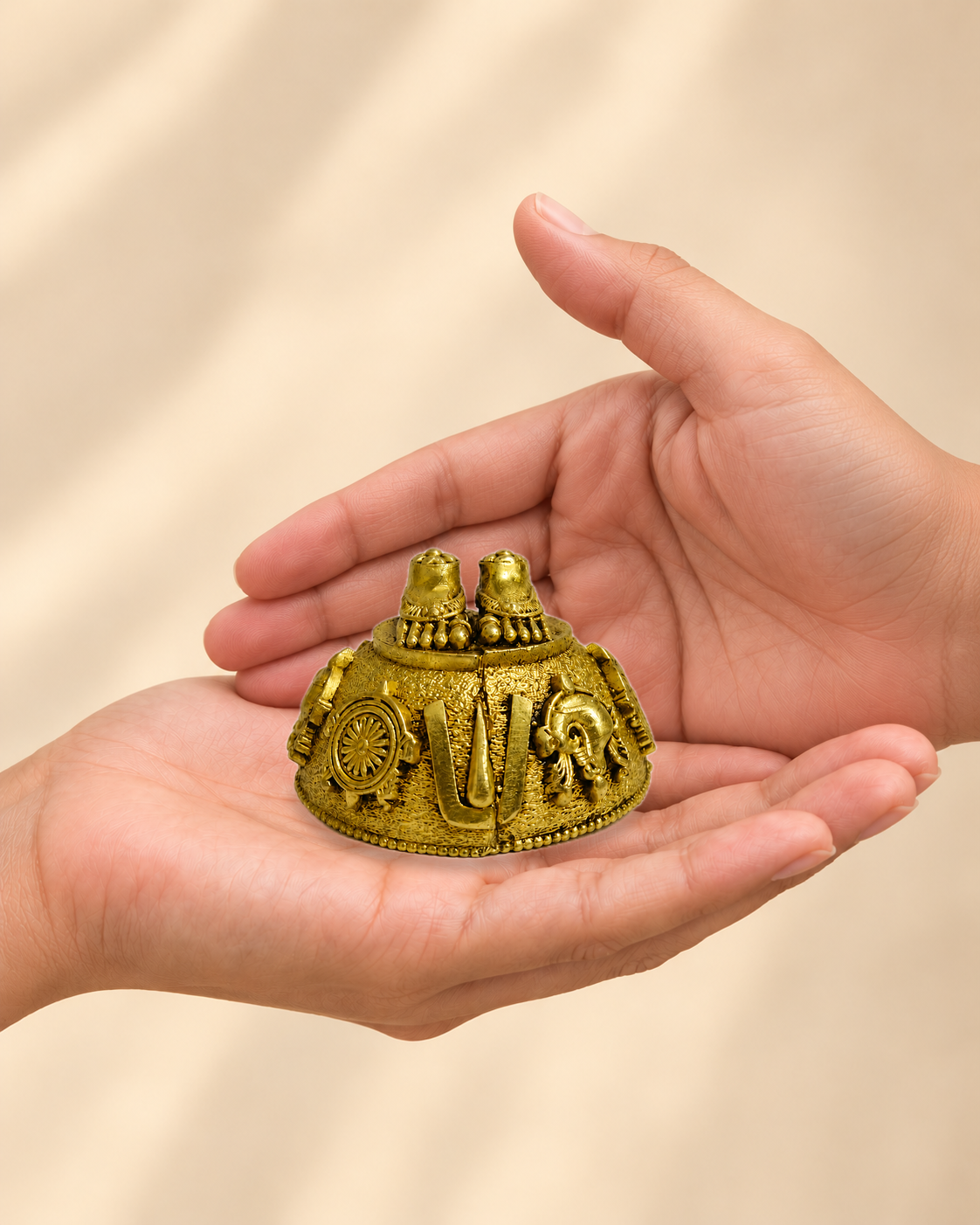 Illustrative scale view of Balaji Charan Paduka Brass Idol resting on an adult open palm; listed height 2 inches.