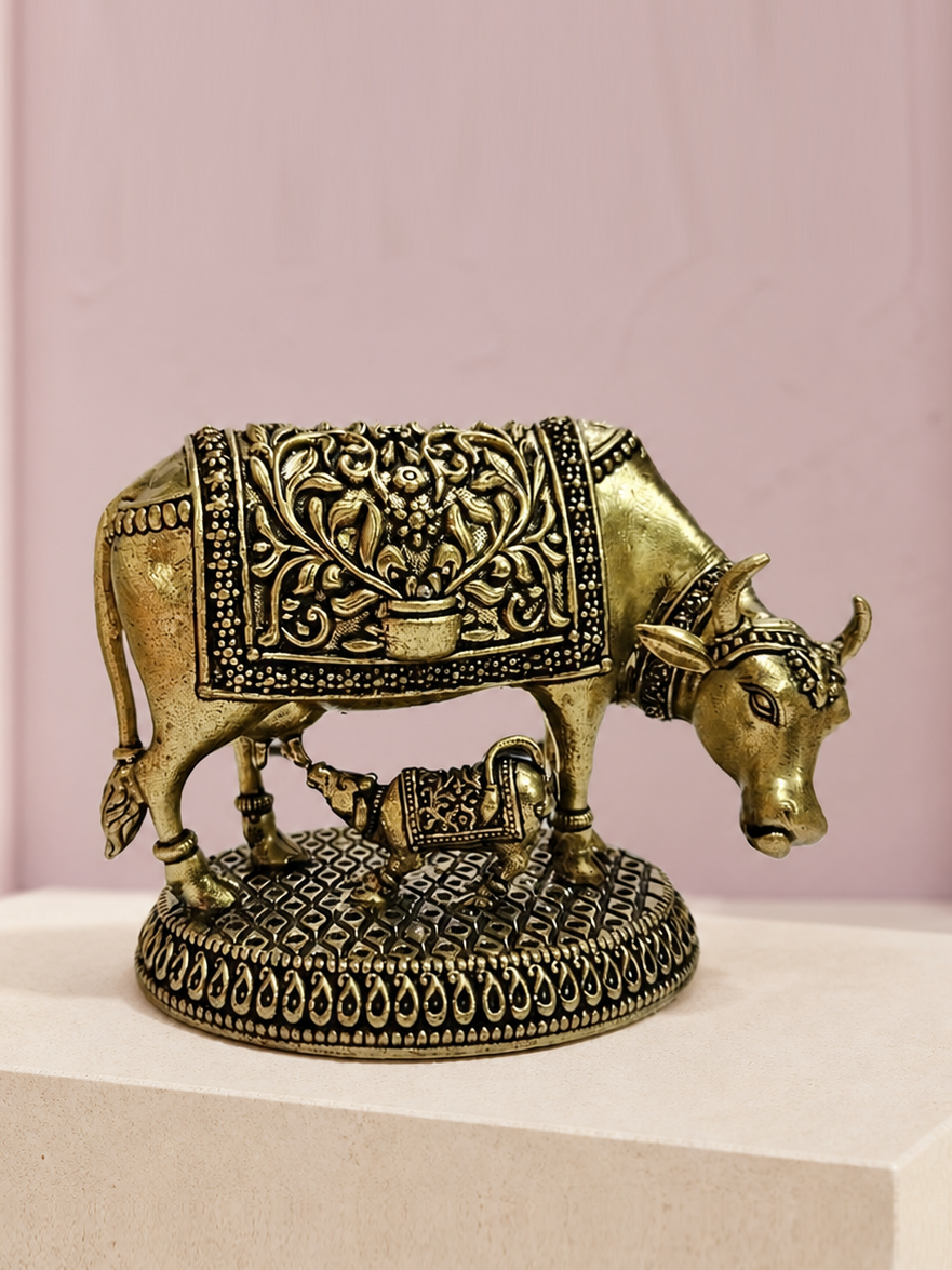 Cow and Calf Brass Idol on an ivory platform with a soft mauve heritage backdrop