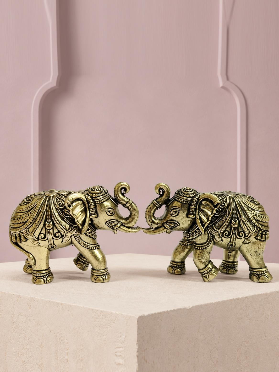 Decorative Brass Elephant Pair on an ivory platform with a soft mauve heritage backdrop