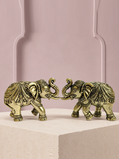 Decorative Brass Elephant Pair on an ivory platform with a soft mauve heritage backdrop