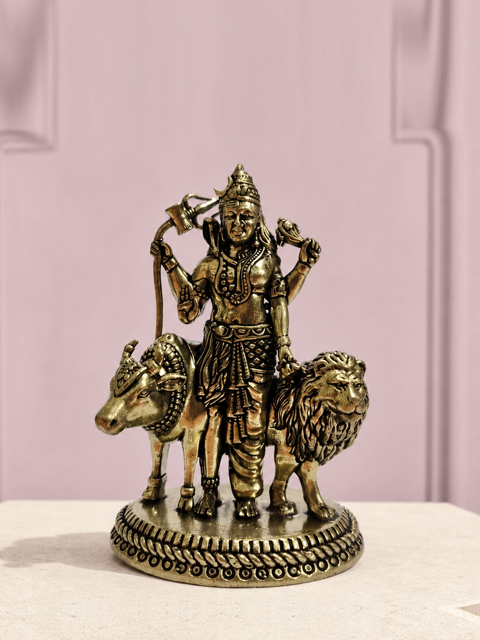 Antique Brass Devotional Idol with Elephant and Lion on an ivory platform with a soft mauve heritage backdrop