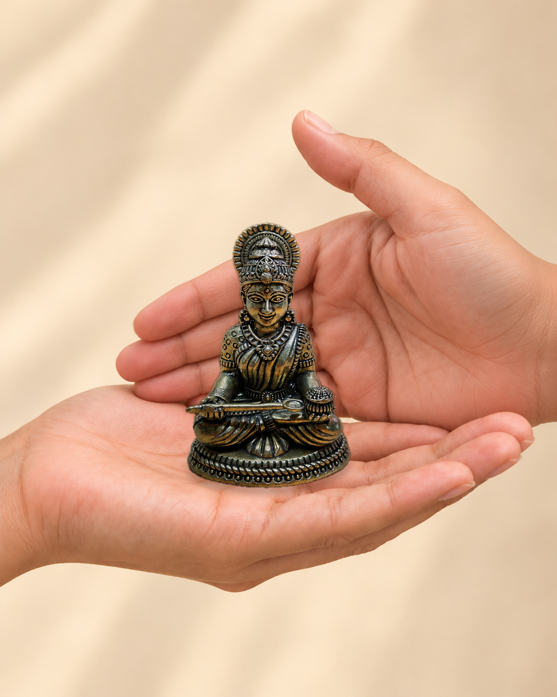 Illustrative scale view of Goddess Annapurna Brass Idol resting on an adult open palm; listed height 3 inches.