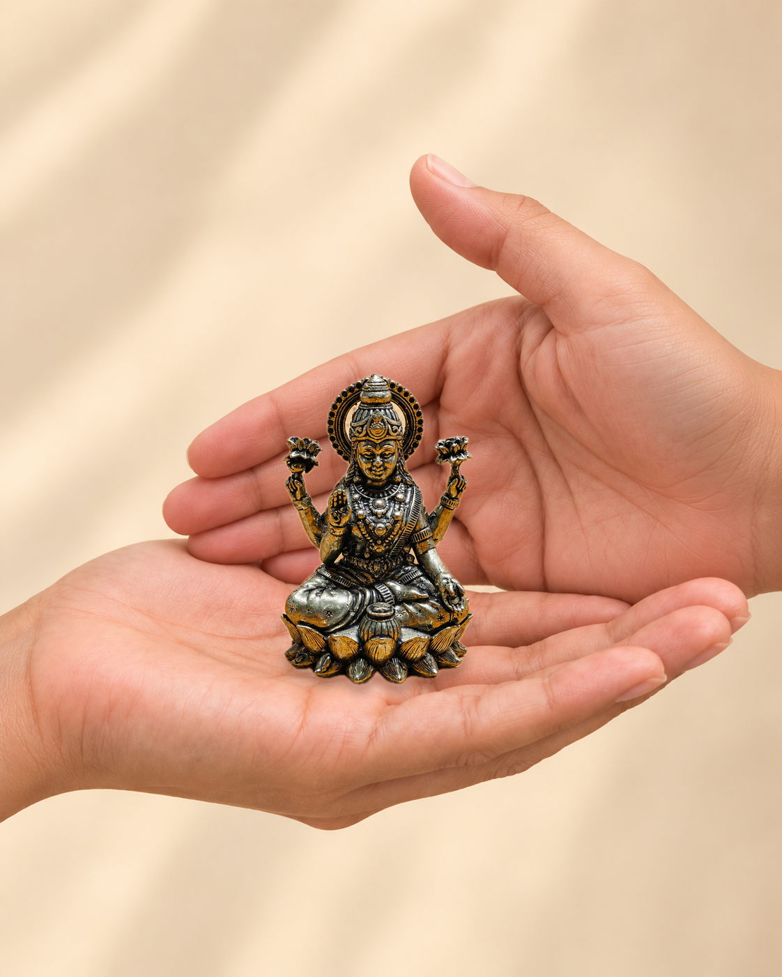 Illustrative scale view of Goddess Lakshmi Brass Idol On Lotus resting on an adult open palm; listed height 2.5 inches.