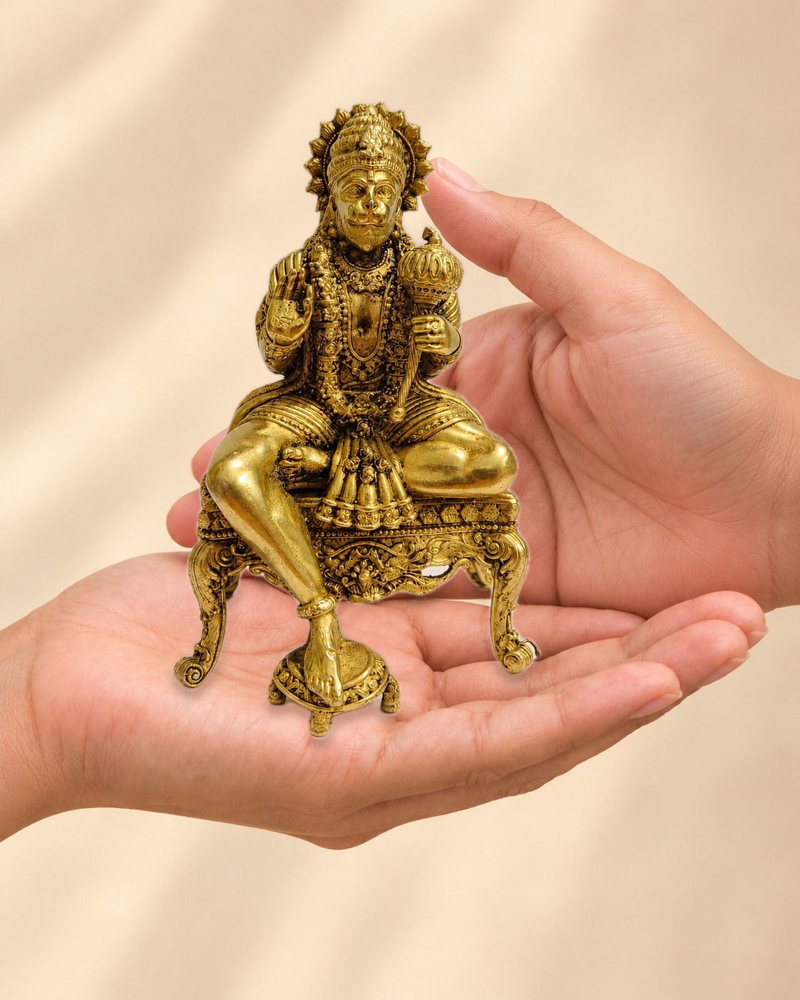 Illustrative scale view of Hanuman on Ornate Throne Brass Idol resting on an adult open palm; listed height 5 inches.
