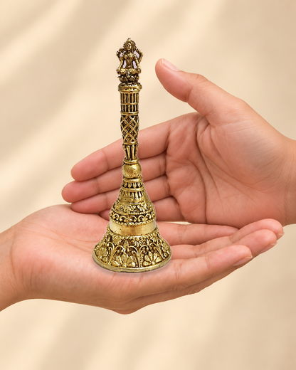 Illustrative scale view of Lakshmi Brass Pooja Bell – 5 Inch resting on an adult open palm; listed height 5 inches.
