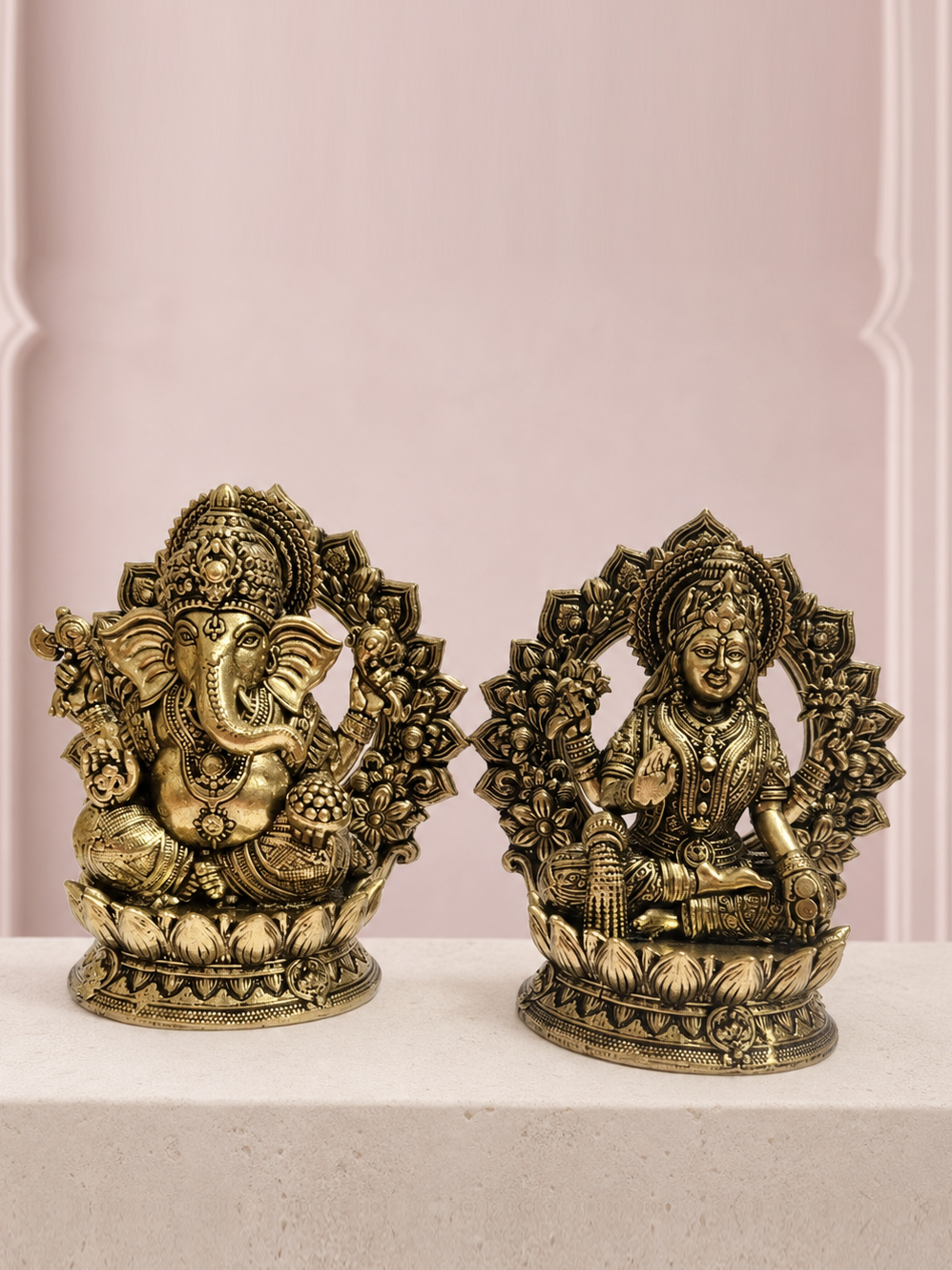 Lakshmi Ganesha Brass Idol Pair with Lotus Backplates on an ivory platform with a soft mauve heritage backdrop