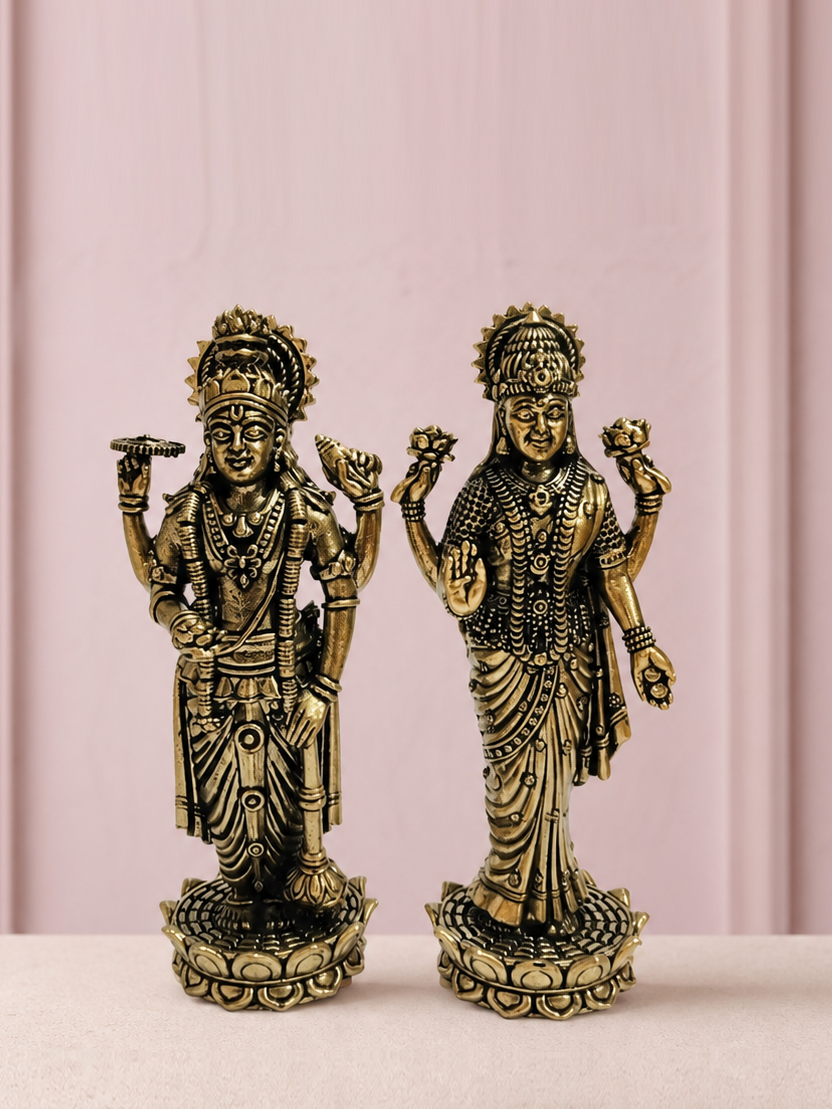 Lakshmi Narayan Brass Idol Pair on an ivory platform with a soft mauve heritage backdrop