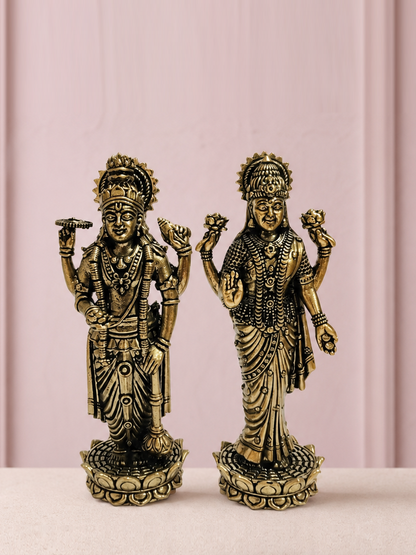 Lakshmi Narayan Brass Idol Pair on an ivory platform with a soft mauve heritage backdrop
