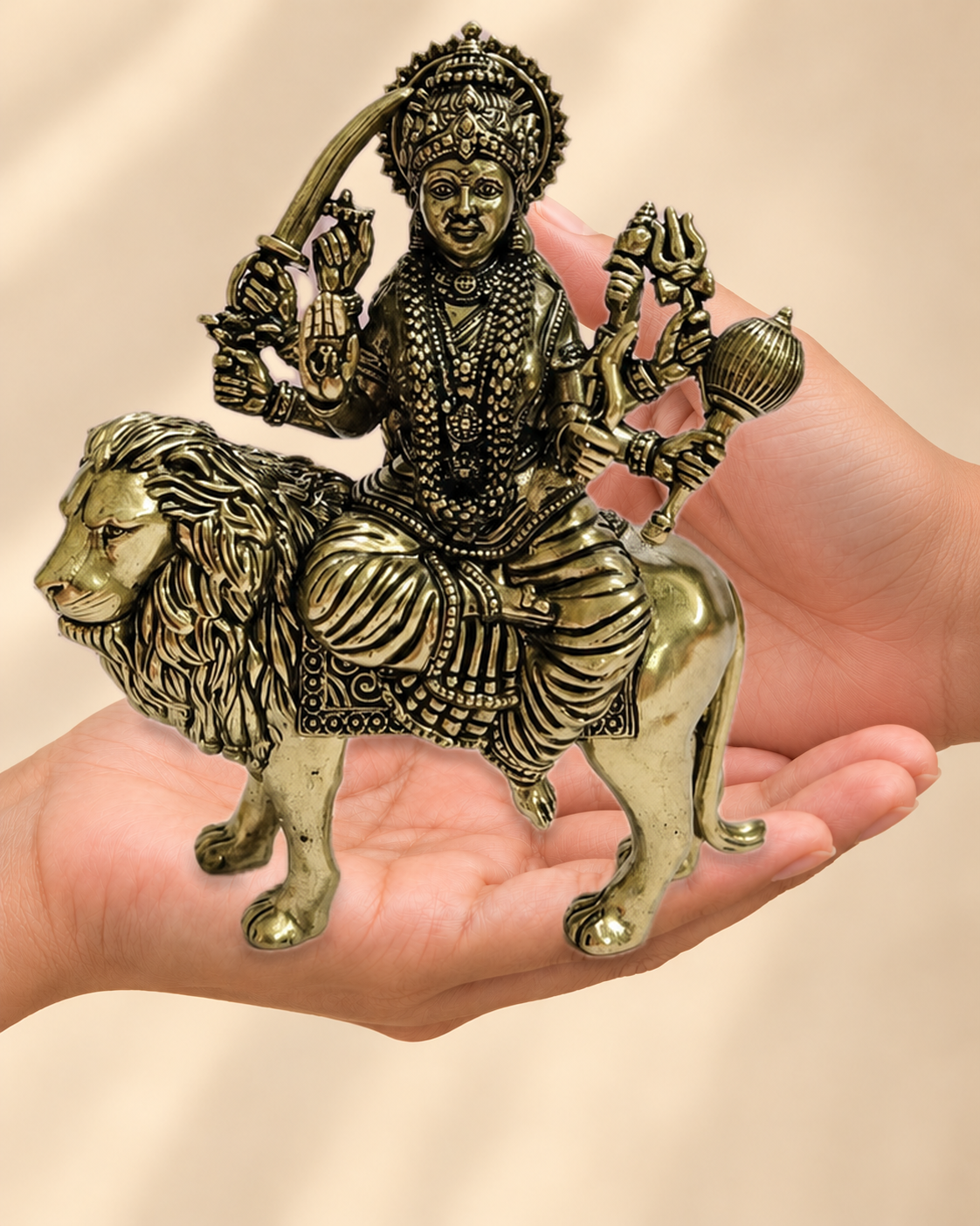 Illustrative scale view of Maa Durga Brass Idol On Lion resting on an adult open palm; listed height 6 inches.