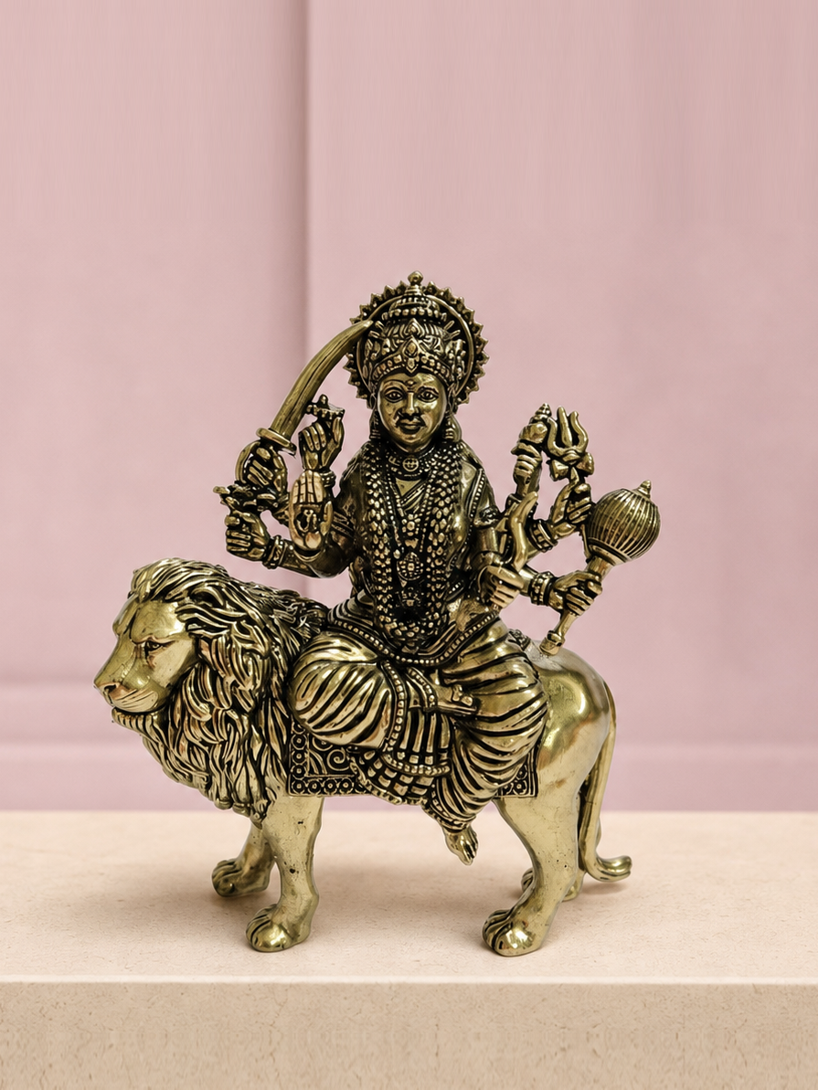 Maa Durga Brass Idol on Lion on an ivory platform with a soft mauve heritage backdrop