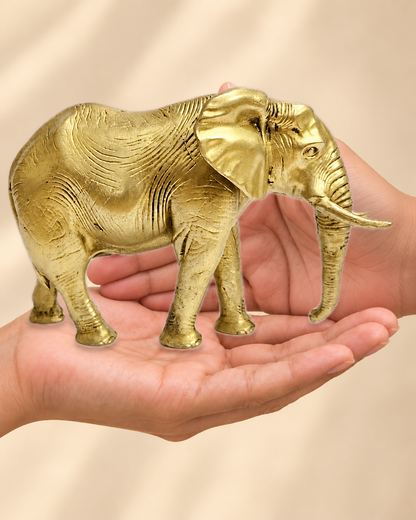 Illustrative scale view of Majestic Standing Brass Elephant Decor – 4 Inch resting on an adult open palm; listed height 4 inches.