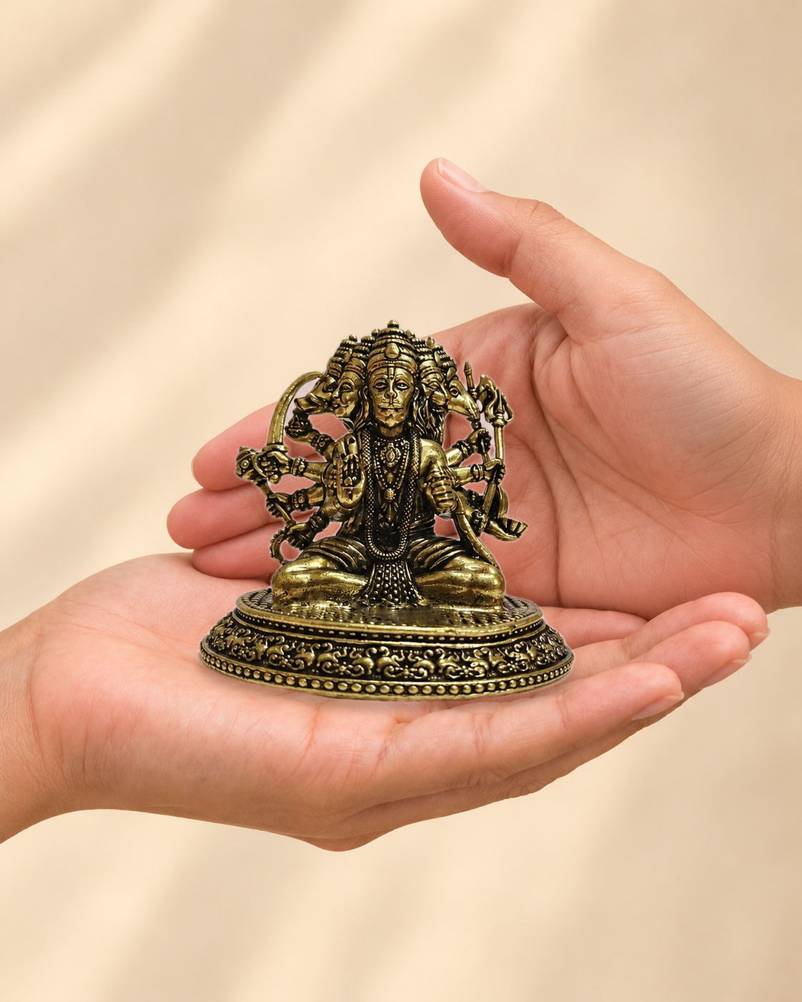 Illustrative scale view of Panchmukhi Hanuman Brass Idol resting on an adult open palm; listed height 3 inches.