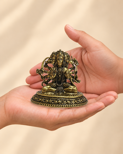 Illustrative scale view of Panchmukhi Hanuman Brass Idol resting on an adult open palm; listed height 3 inches.