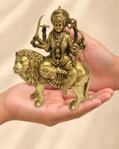 Illustrative scale view of Polished Brass Maa Durga Idol on Lion – 5.5 Inch resting on an adult open palm; listed height 5.5 inches.
